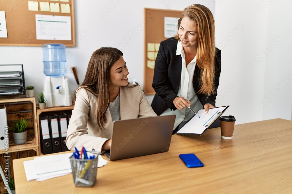 Mother and daughter business workers smiling confident working at office Mother and daughter business workers smiling confident working at office
