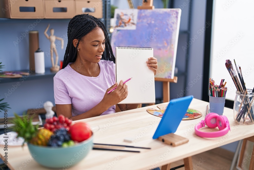 African american woman artist having online draw class at art studio African american woman artist having online draw class at art studio