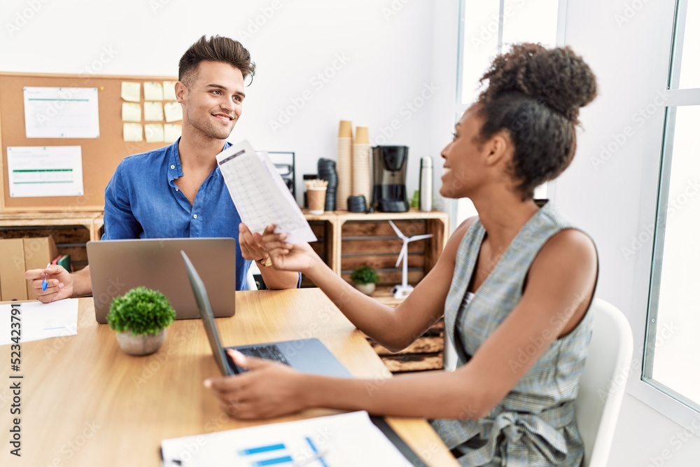 Fototapeta premium Man and woman business workers smiling confident working at office