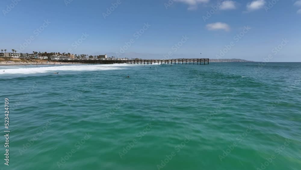 Drone flying over waves near surfers towards Crystal Pier, 4K Drone flying over waves near surfers towards Crystal Pier, 4K