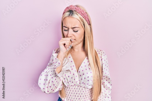 Young blonde girl wearing casual clothes feeling unwell and coughing as symptom for cold or bronchitis. health care concept.