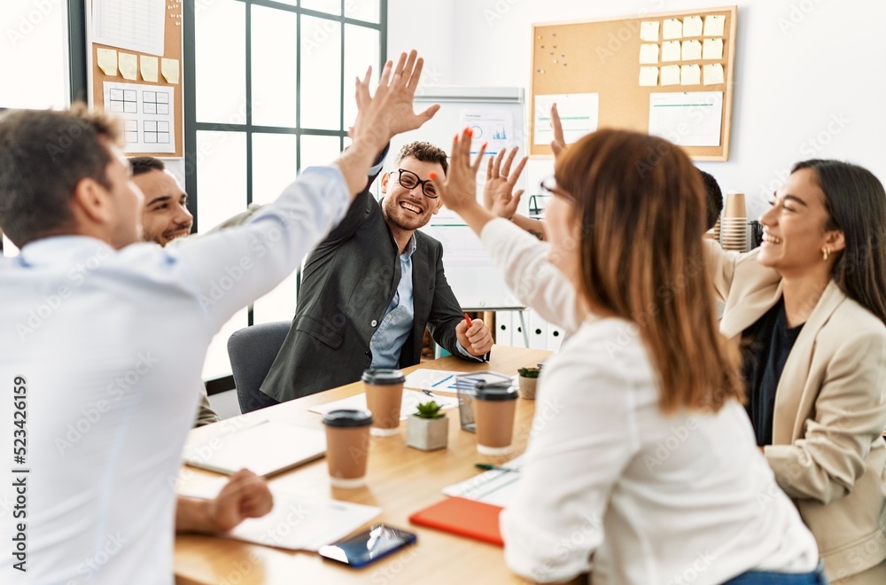 © Krakenimages.com - Group of business workers smiling happy celebrating high five at the office.
