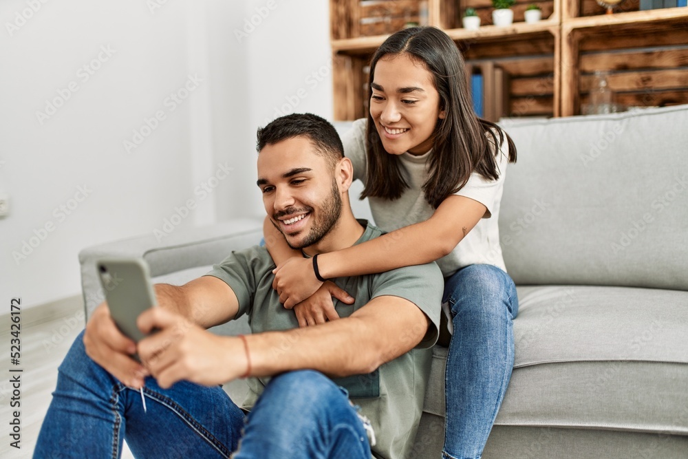 Young latin couple smiling happy making selfie by the smartphone at home. Young latin couple smiling happy making selfie by the smartphone at home.