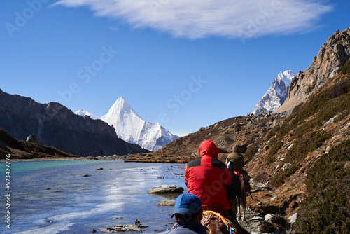 Photography asian tourists on horseback traveling in yading national park in daocheng county