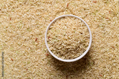 Thai brown rice seeds in bowl, Organic rice, top view
