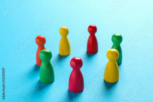 Colorful pawns on light blue background, closeup. Social inclusion concept © New Africa