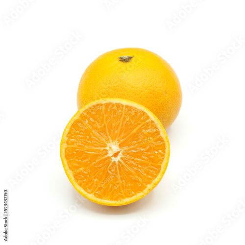 Halved oranges and one oranges look fresh appetizing on white background.
