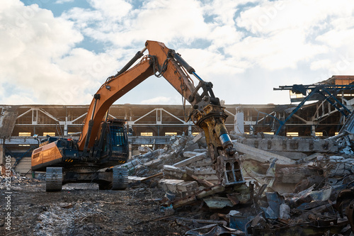 Excavator destroyer removes debris Building demolition