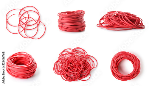 Group of red elastic bands on white background
