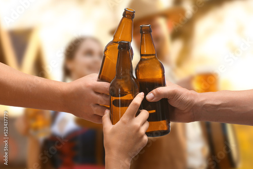 Friends clinking bottles wi...