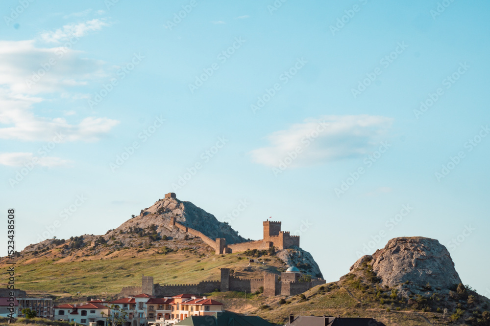 Genoese fortress on the mountain. Fortress on a high mountain. An old fort with towers on the mountain.