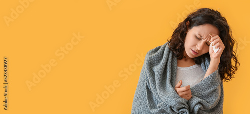 Woman ill with flu on yello...
