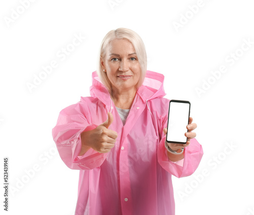 Mature woman in raincoat wi...