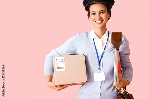 Young postwoman with parcel...