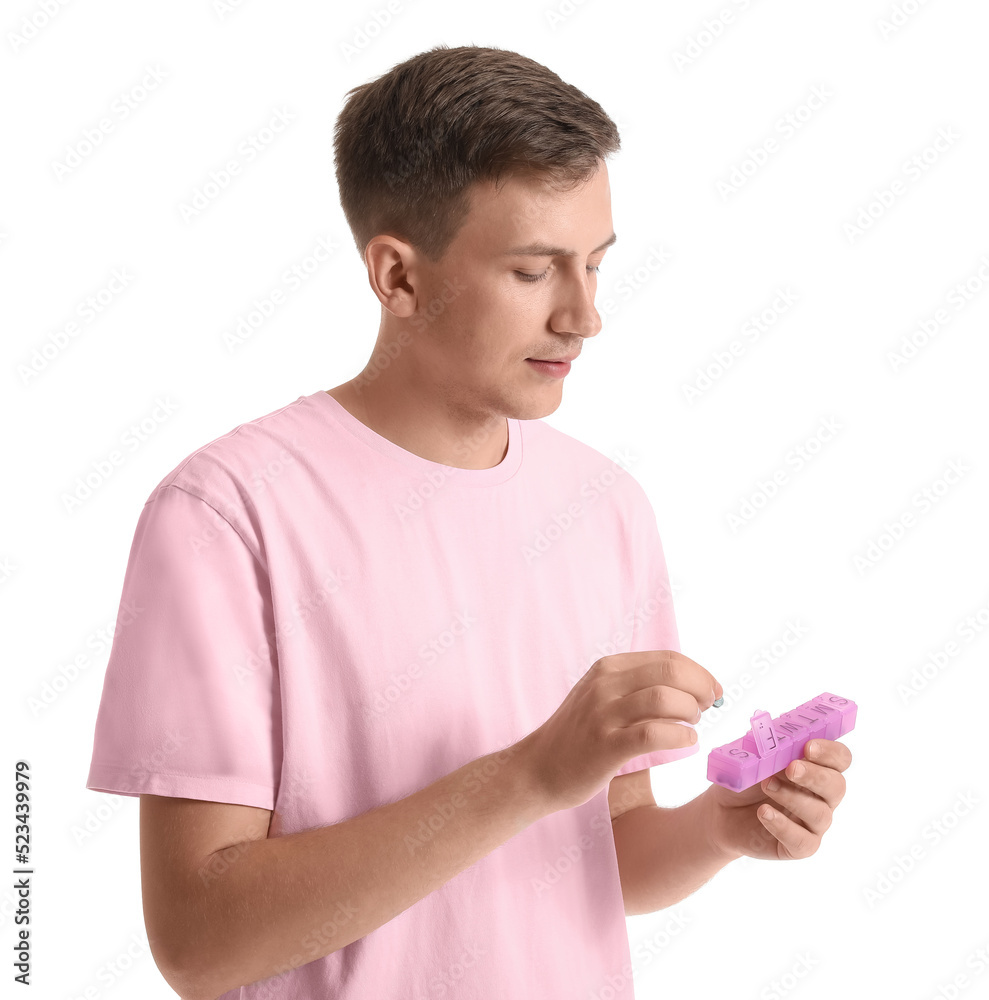 Young man holding container with pills on white background Young man holding container with pills on white background
