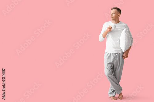 Young man with cup of coffe...