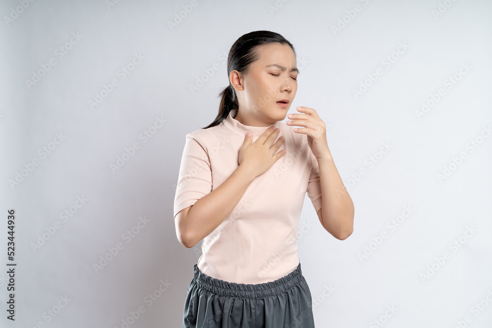 Asian woman was sick with sore throat standing isolated on white background. Asian woman was sick with sore throat standing isolated on white background.