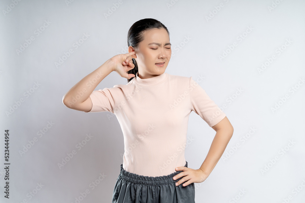 Woman itching putting a finger into her ear. Woman itching putting a finger into her ear.