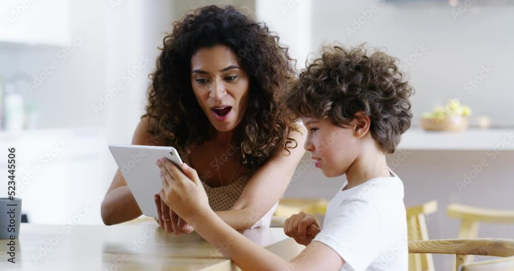 Mother and son with tablet playing games, talking and bonding while searching interactive education activity on tech. Slow motion of parent and adorable, cute or curious boy enjoying home family time