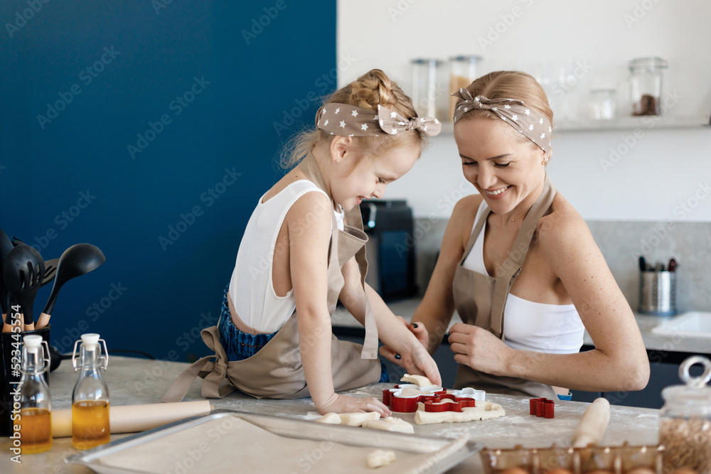 mother and daughter cooking and baking in the kitchen