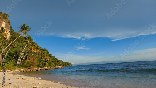 beautiful beach combination of sea waves, white sand and mountains. Afternoon photo in the city of Gorontalo August 13, 2022