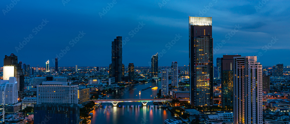 Concept of financial business Technology and travel in Asia cityscape urban landmark,bangkok and River side at night.Thailand night city skyline with modern Bangkok skyscraper architecture building