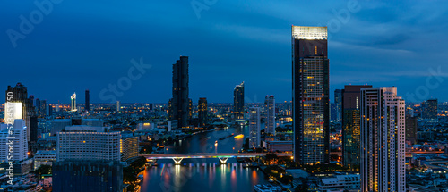 Concept of financial business Technology and travel in Asia cityscape urban landmark,bangkok and River side at night.Thailand night city skyline with modern Bangkok skyscraper architecture building
