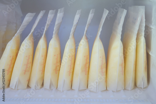Stock of breast milk frozen in storage bags for a new baby of family in the freezer of refrigerator.