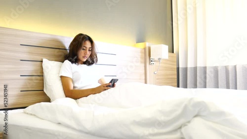 women use smartphone for shopping online, Relax, watch series on the bed room
