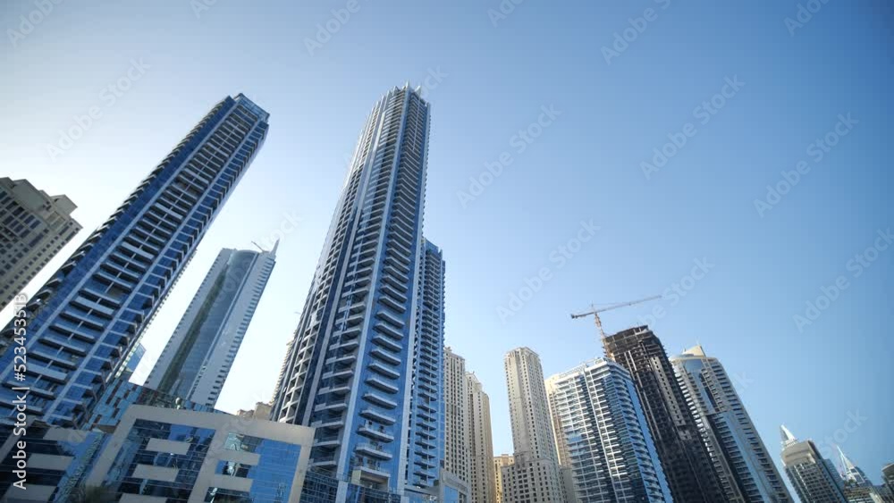 Residential Towers and Skyscrapers in Dubai Marina UAE, Low Angle View From Moving Boat Residential Towers and Skyscrapers in Dubai Marina UAE, Low Angle View From Moving Boat