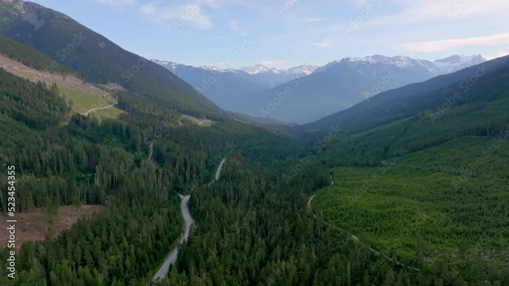 Highway 99 Through Dense Pine Forest On The Mountain In Pemberton, British Columbia, Canada. aerial pullback Highway 99 Through Dense Pine Forest On The Mountain In Pemberton, British Columbia, Canada. aerial pullback