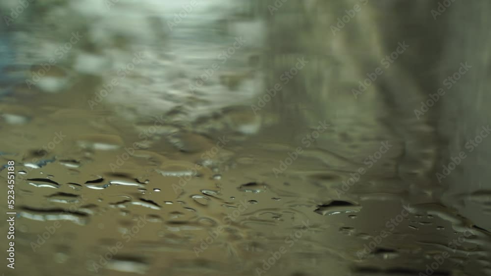 This is rainwater that drips onto the windshield of the car. This is rainwater that drips onto the windshield of the car.
