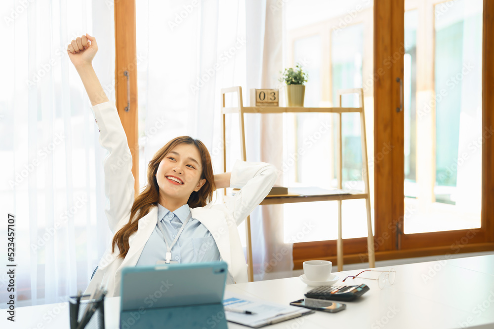 Successful business concept, Businesswoman raising arm to stretching after hard working new project Successful business concept, Businesswoman raising arm to stretching after hard working new project