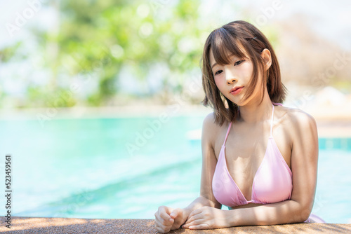 Portrait beautiful young asian woman enjoy around outdoor swimming pool
