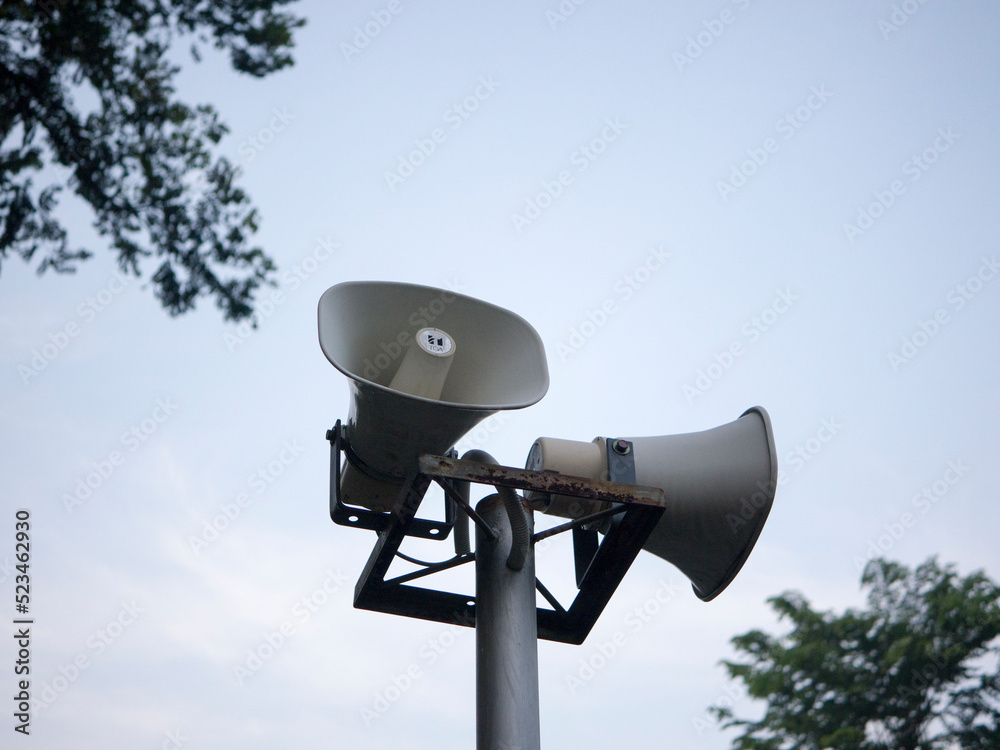 Horn speaker for public relations sign symbol on sky background Horn speaker for public relations sign symbol on sky background