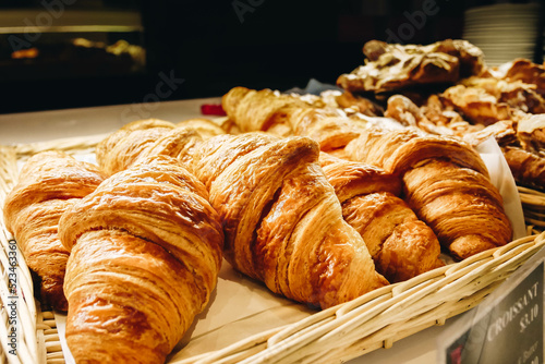 close up of freshly baked croissants on a wooden table