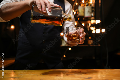 Barman pouring whiskey whiskey glass beautiful night