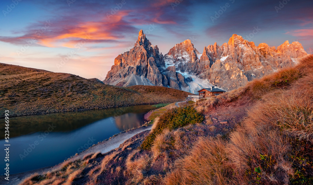 Gorgeous autumn sunset in Dolomite Alps. Wonderful evening view of popular tourist destination - Baita Segantini pass. Colorful outdoor scene of Italy. Beauty of nature concept background..