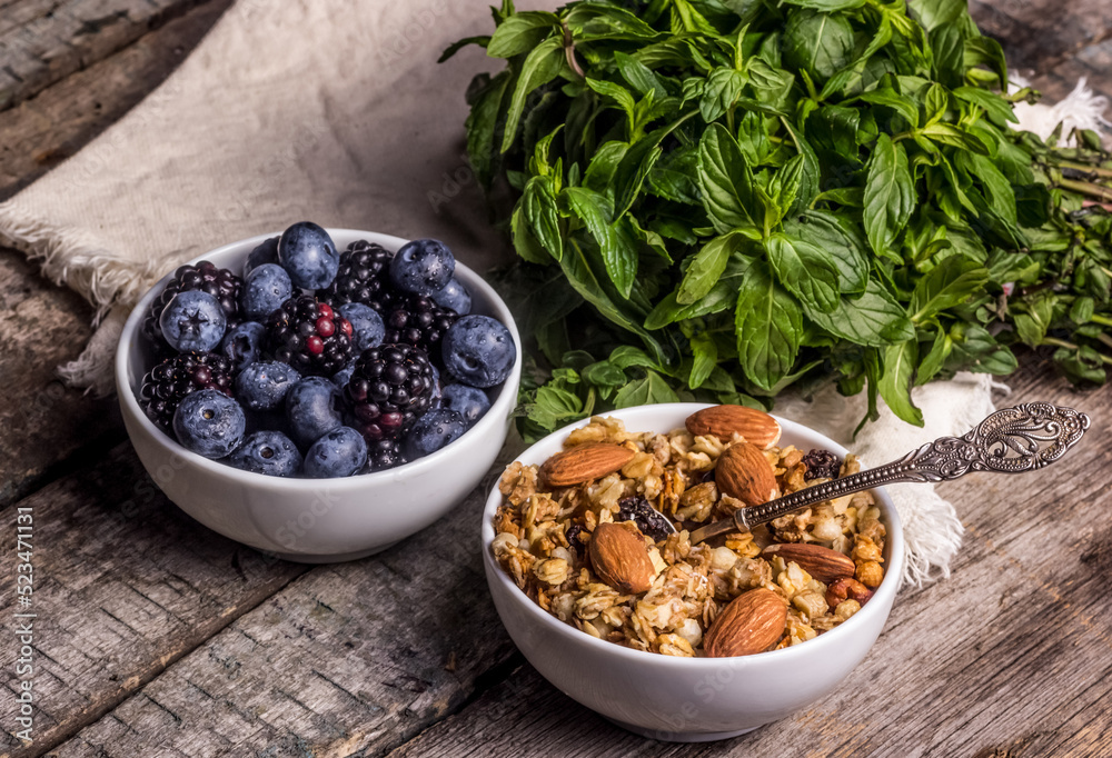 Muesli with almonds and fresh berries. Granola with blueberries and blackberries.