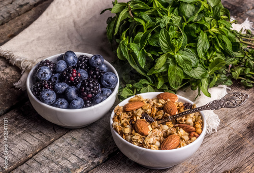 Obraz na płótnie Muesli with almonds and fresh berries. Granola with blueberries and blackberries. w salonie