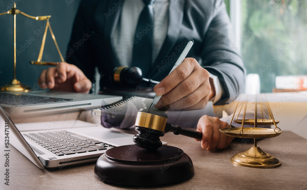 Male lawyer working with contract papers and wooden gavel on tabel in courtroom. justice and law ,attorney, court judge, concept. Male lawyer working with contract papers and wooden gavel on tabel in courtroom. justice and law ,attorney, court judge, concept.