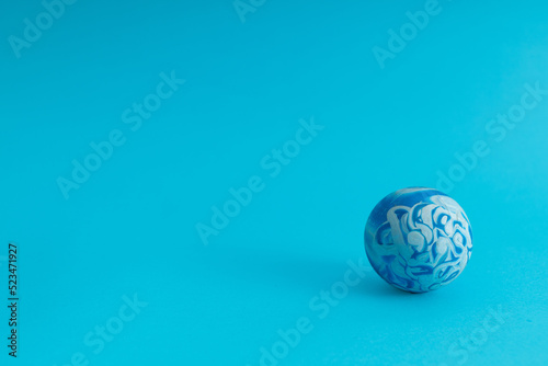 Blue ball in stains on a blue background  monochrome