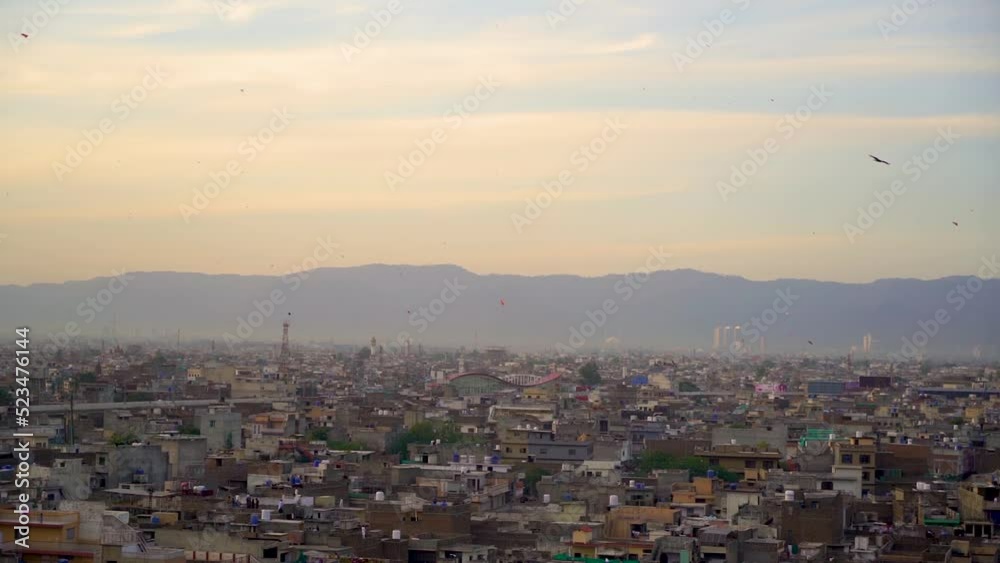Slow Motion kite flying festival Basant in Pakistan in the evening with city from the top view Slow Motion kite flying festival Basant in Pakistan in the evening with city from the top view