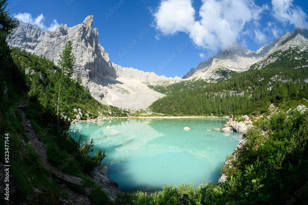 Stunning view of Lake Sorapis with its turquoise waters surrounded by beautiful rocky mountains. Lake Sorapis is one of the most beautiful excursions in the Dolomites, Italy.