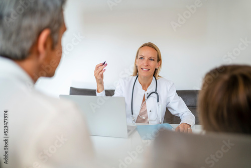 Female doctor with father and son in medical practice