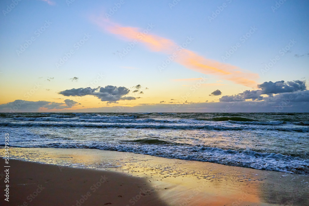Sea sand beach landscape. Seascape background. Sunset sky over ocean water surface with calm waves, Summer mood and vacation travel holiday