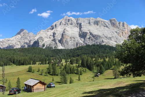 Val Badia, Italy-July 17, 2022: The italian Dolomites behind the small village of Corvara in summer days with beaitiful blue sky in the background. Green nature in the middle of the rocks.
