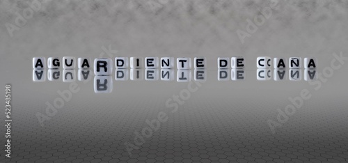 aguardiente de caña word or concept represented by black and white letter cubes on a grey horizon background stretching to infinity