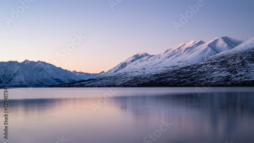 Snow-capped mountains reflected in Lake Ohau at sunset, Twizel, South Island. photo