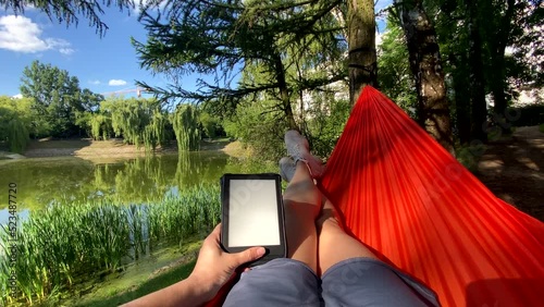 point of view woman laying down on the hammock reading book